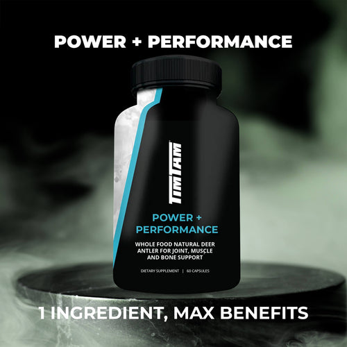 Black supplement bottle labeled 'Power + Performance' on a dark background
